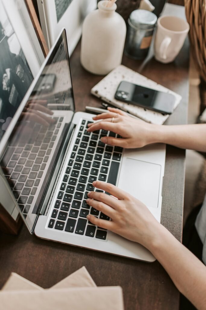 A person using a modern laptop on a tidy desk, suitable for a laptop buying guide.